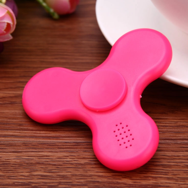 Fidget Spinner pink auf Tisch